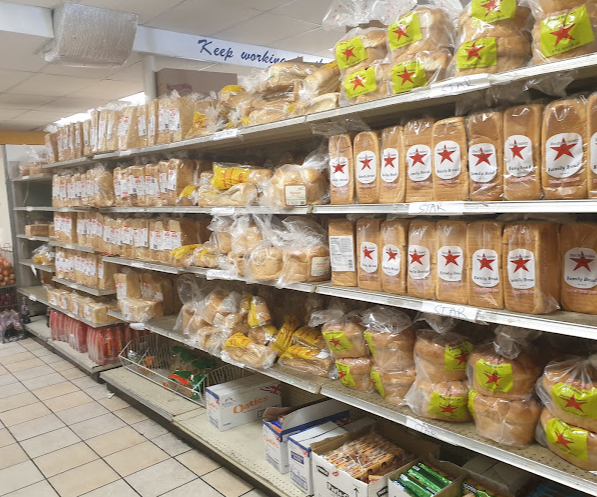 Bread aisle stocked with fresh loaves and baked goods